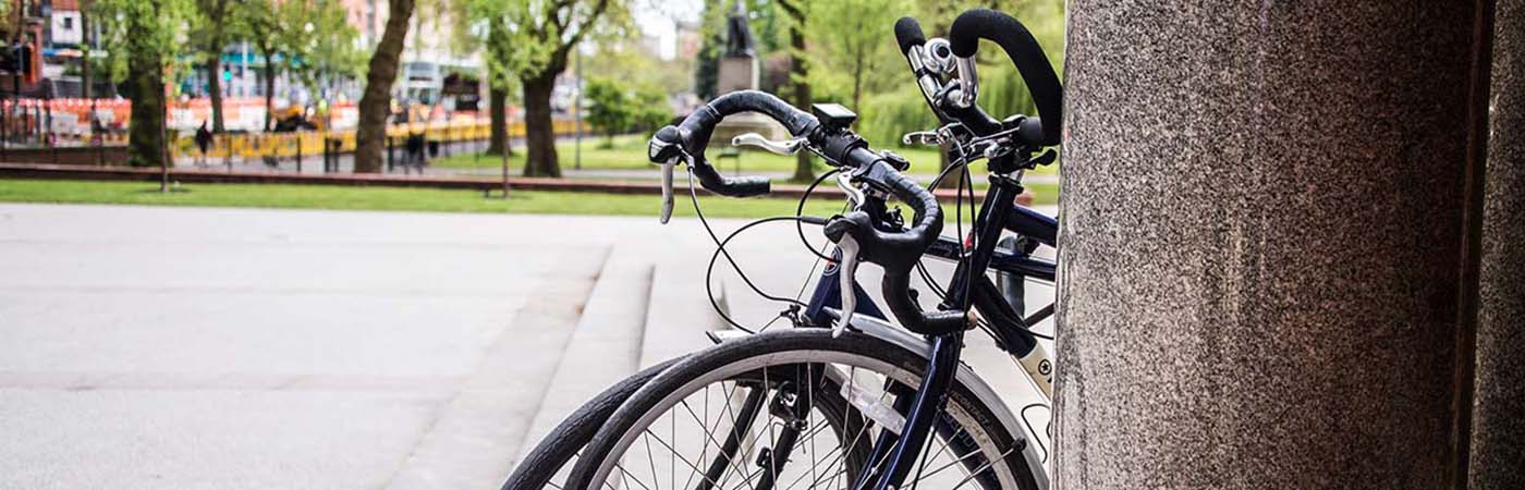 Bicycles leaning against a wall on campus