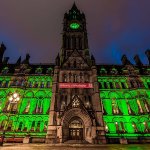 Manchester town hall lit up in green