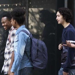 Young people smiling and walking in a group
